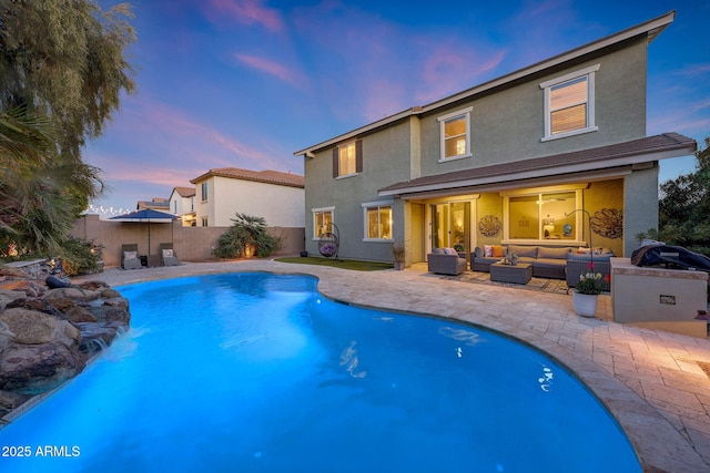 pool at dusk featuring a patio and an outdoor hangout area