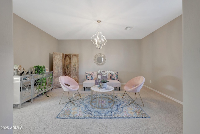 sitting room with a notable chandelier and carpet flooring