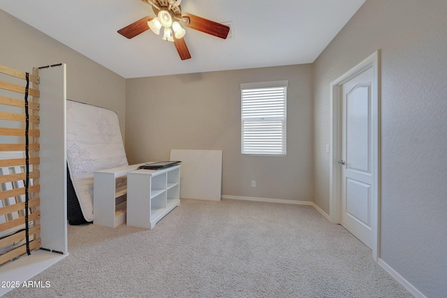 unfurnished bedroom with ceiling fan and light colored carpet