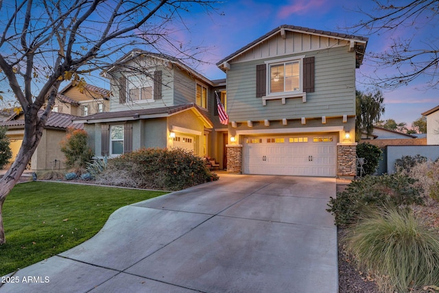 view of front of house featuring a garage and a lawn