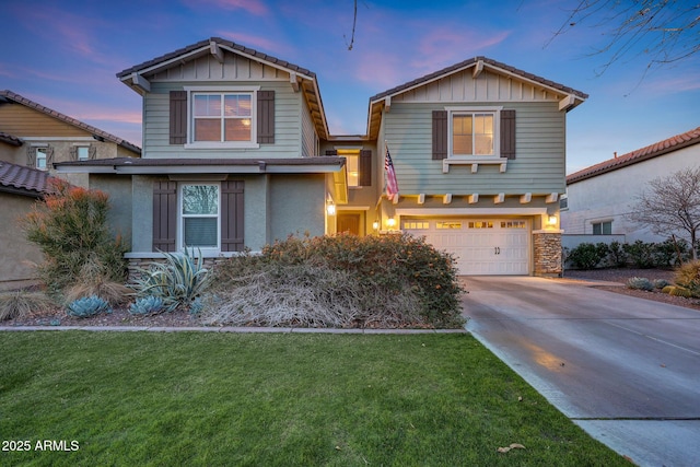 view of front of home featuring a garage and a lawn