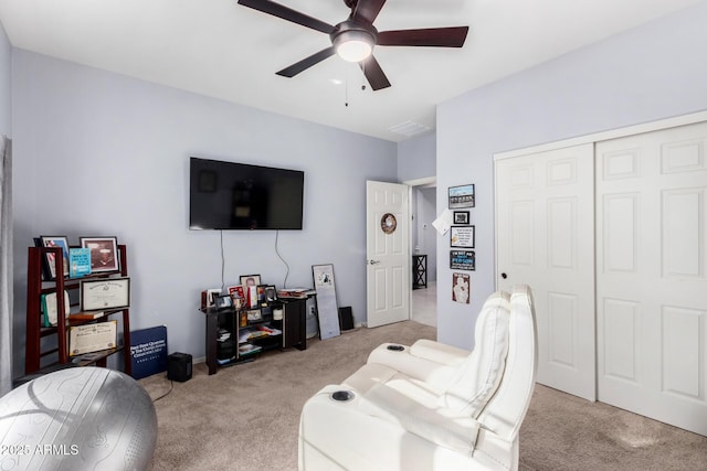 carpeted living room featuring ceiling fan