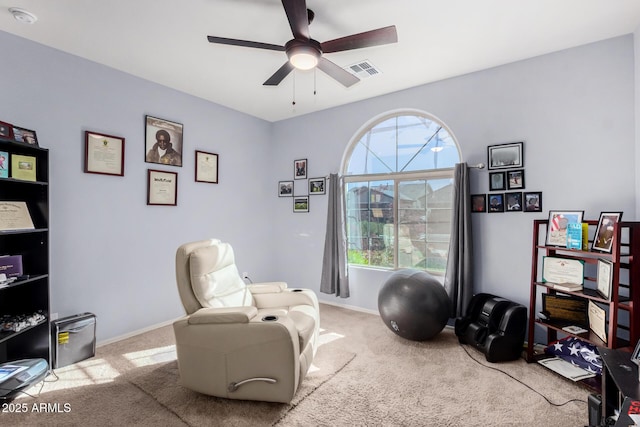 living area featuring ceiling fan and light carpet