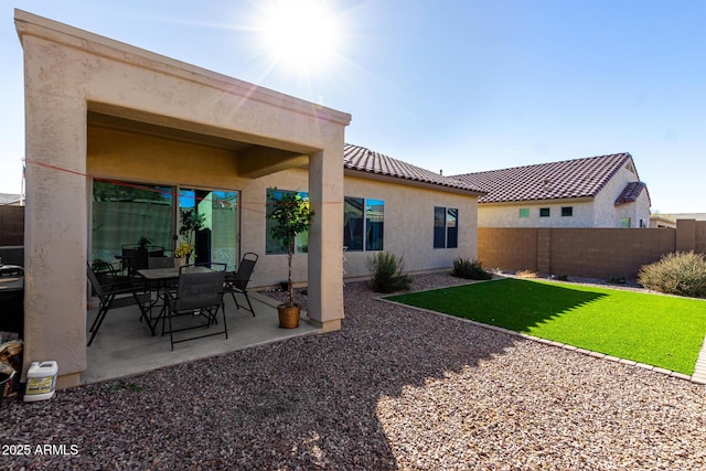 back of house featuring a yard and a patio