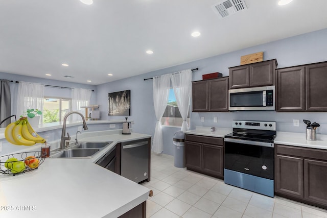 kitchen featuring sink, dark brown cabinetry, and stainless steel appliances