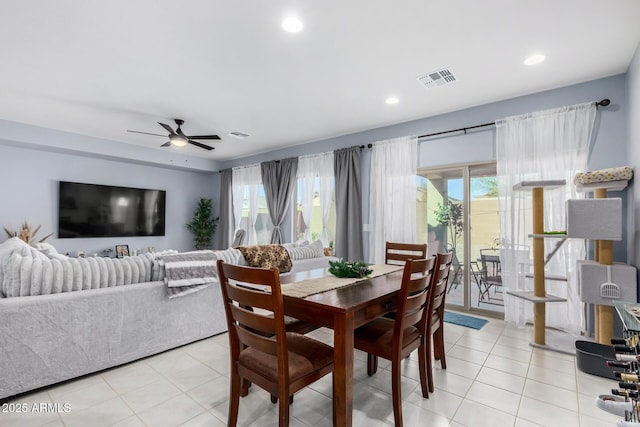 dining space featuring light tile patterned floors and ceiling fan