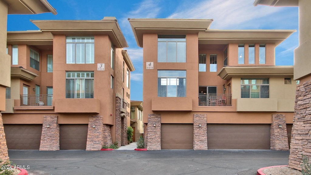 view of front of house with a balcony and a garage