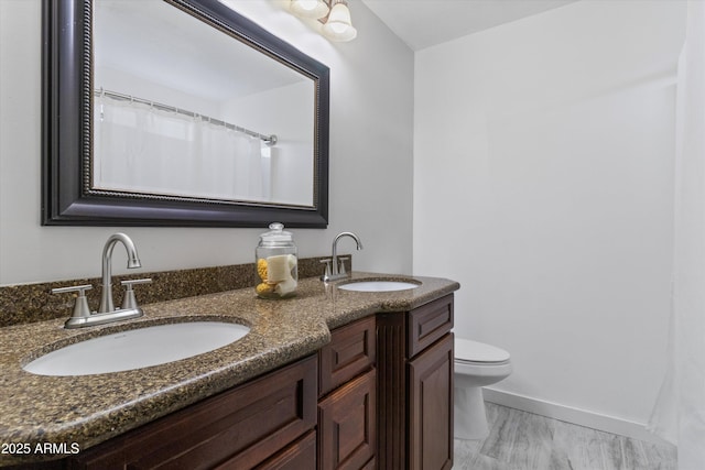 bathroom featuring vanity and toilet