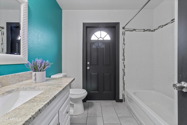 full bathroom featuring vanity, tile patterned flooring, tiled shower / bath combo, and toilet