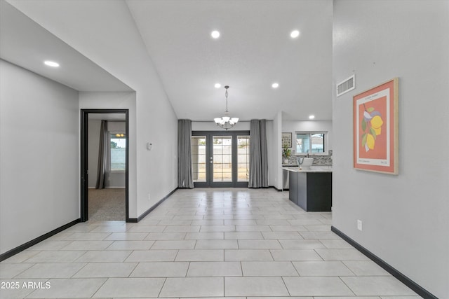 interior space featuring a notable chandelier and french doors