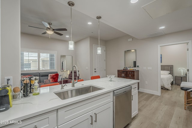 2038 E River Rd Unit 101, Tucson, AZ 85718 - kitchen featuring stainless steel dishwasher, a sink, white cabinetry, open floor plan, and recessed lighting