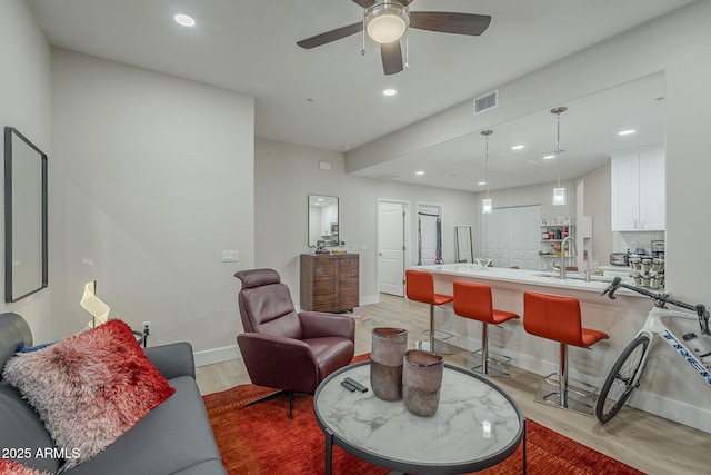 2038 E River Rd Unit 101, Tucson, AZ 85718 - living room featuring recessed lighting, a ceiling fan, light wood-style floors, and baseboards