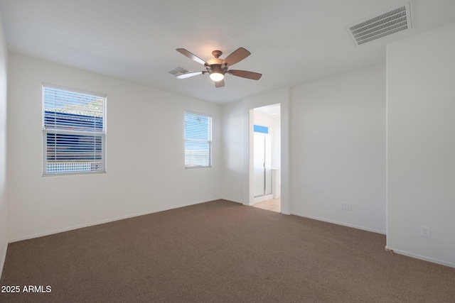 empty room with carpet floors and ceiling fan