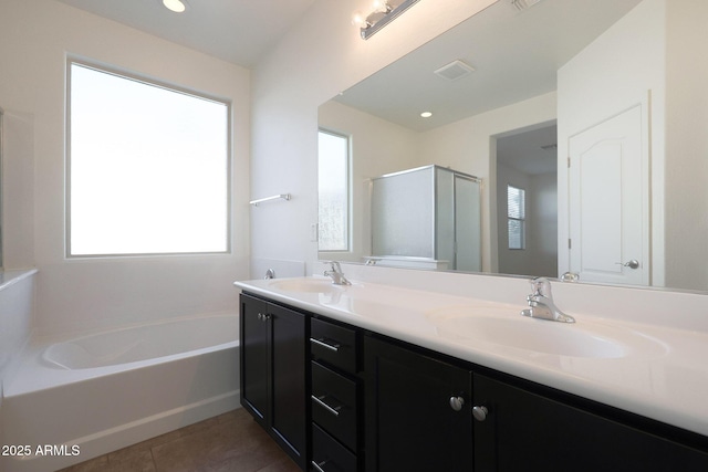 bathroom with vanity, shower with separate bathtub, tile patterned flooring, and a healthy amount of sunlight