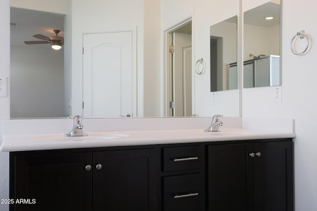 bathroom with ceiling fan, vanity, and a shower with shower door