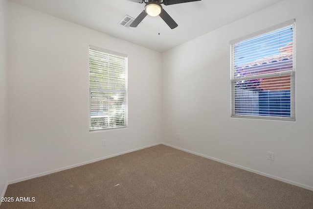 spare room featuring ceiling fan and carpet flooring