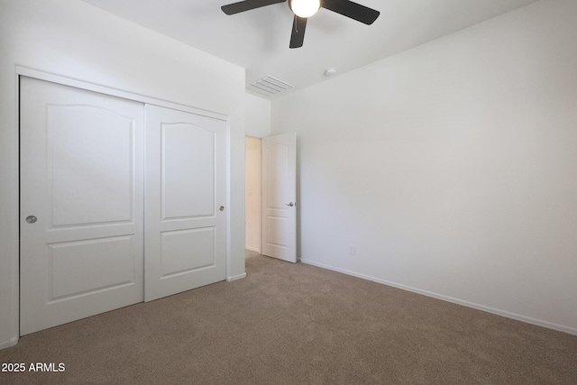 unfurnished bedroom featuring light carpet, a closet, and ceiling fan