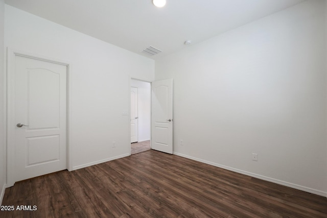 empty room with dark wood-type flooring