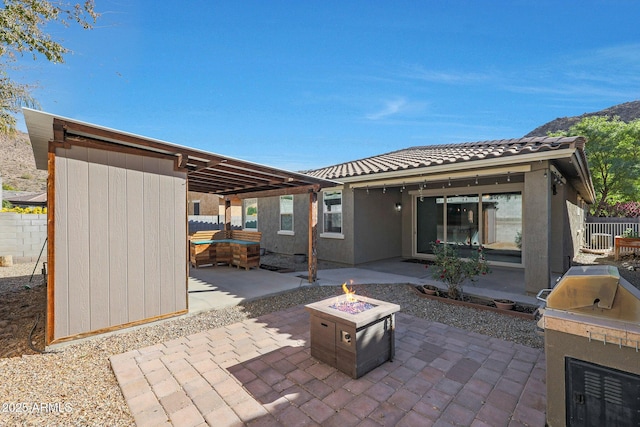 view of patio featuring an outdoor fire pit and area for grilling