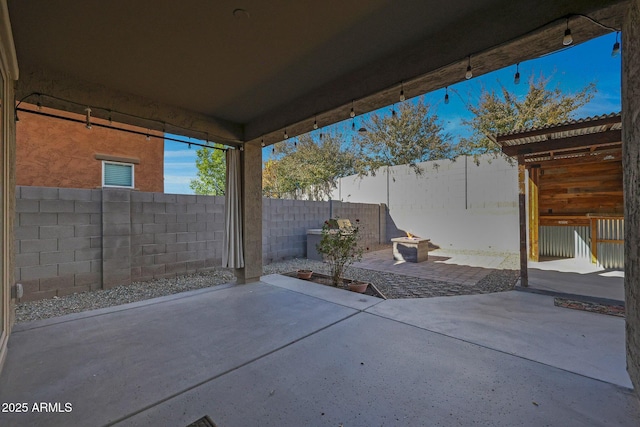 view of patio with a fire pit