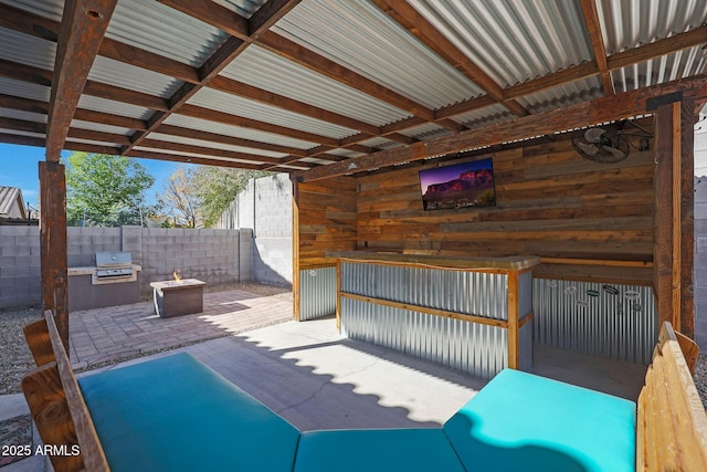 view of patio featuring an outdoor kitchen and a grill