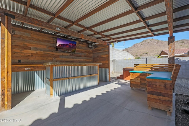 view of patio with a hot tub and a mountain view