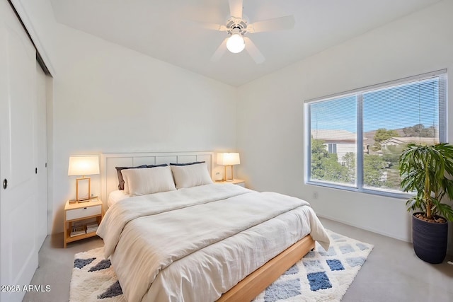 carpeted bedroom featuring a ceiling fan and a closet