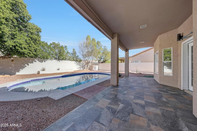 view of pool featuring a fenced backyard, a fenced in pool, and a patio area