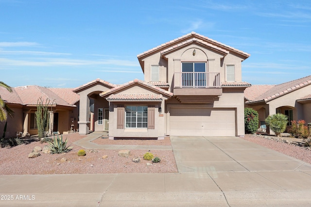 mediterranean / spanish-style house featuring a balcony, stucco siding, a tiled roof, concrete driveway, and an attached garage