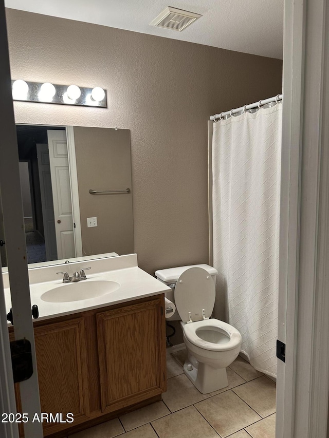 bathroom with tile patterned floors, toilet, and vanity