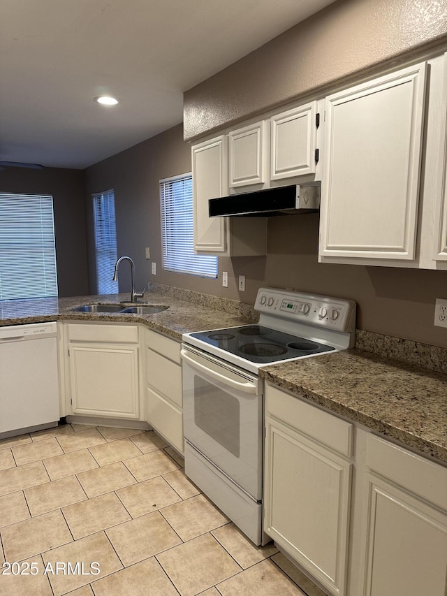 kitchen with light tile patterned flooring, sink, white appliances, and white cabinetry