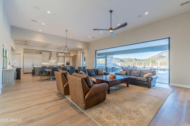 living room with a mountain view, a chandelier, and light hardwood / wood-style floors