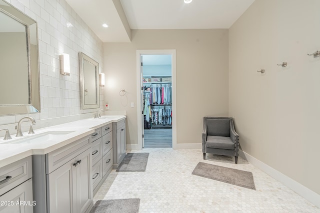 bathroom featuring vanity, backsplash, tile patterned floors, and tile walls