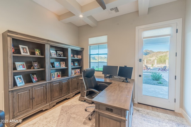 office area with beamed ceiling and light wood-type flooring