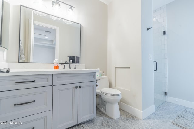 bathroom featuring vanity, toilet, and a shower with shower door