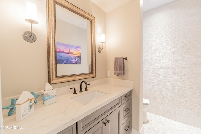 bathroom featuring vanity and toilet