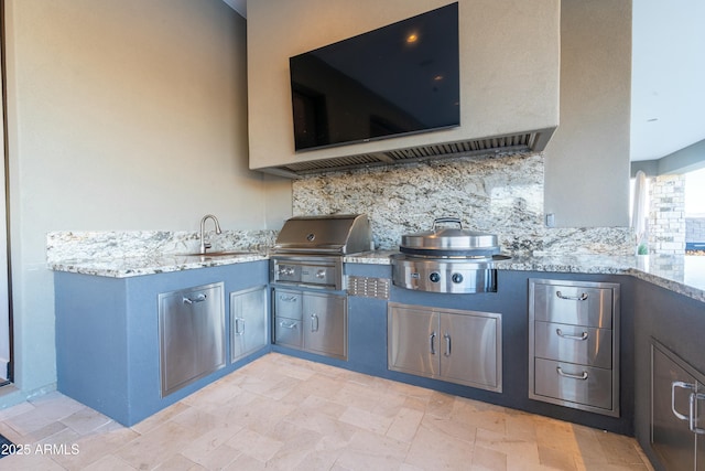 view of patio with a grill, an outdoor kitchen, and sink