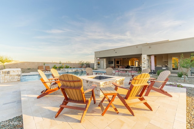 view of patio / terrace featuring a fire pit and pool water feature