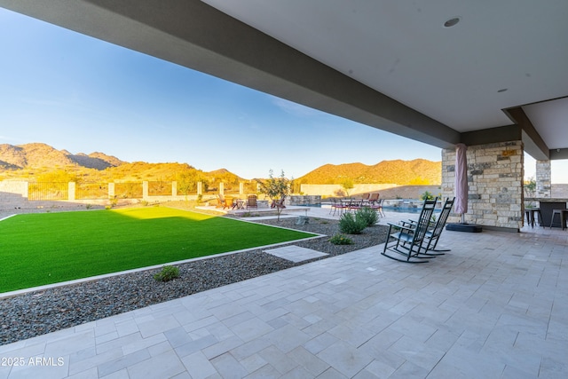 view of patio featuring a mountain view and a swimming pool