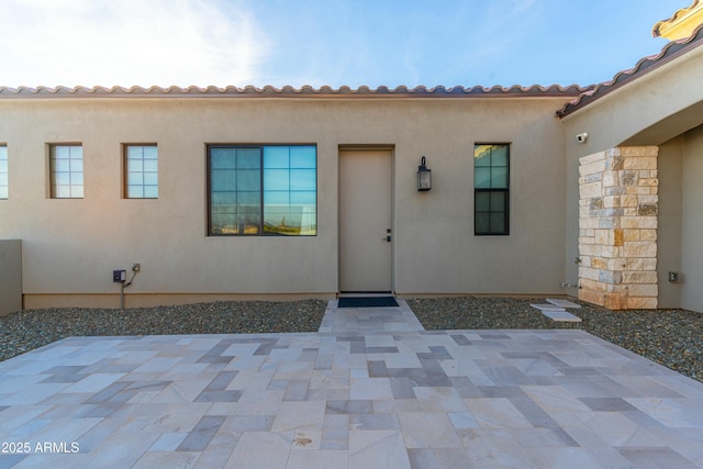 entrance to property featuring a patio area