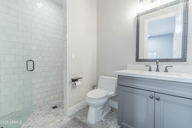 bathroom with vanity, toilet, tile patterned floors, and a shower with shower door