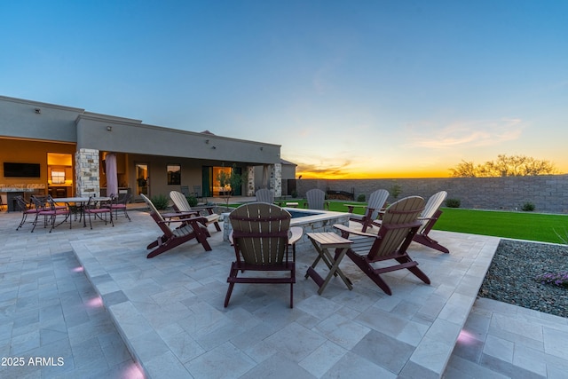 view of patio terrace at dusk