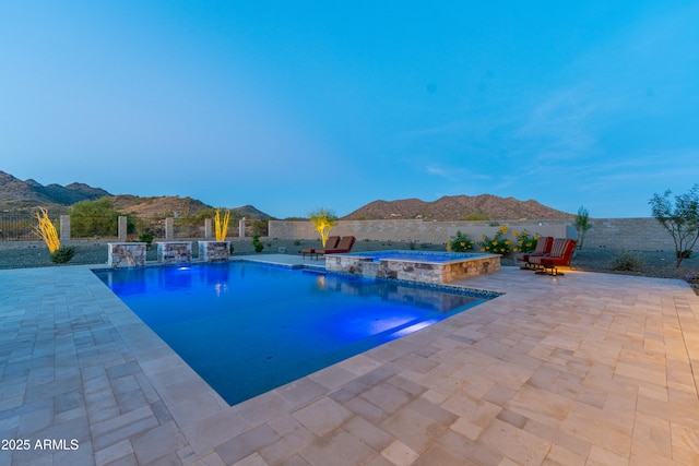 view of pool featuring an in ground hot tub, a mountain view, pool water feature, and a patio