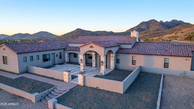 mediterranean / spanish home featuring a mountain view and a patio