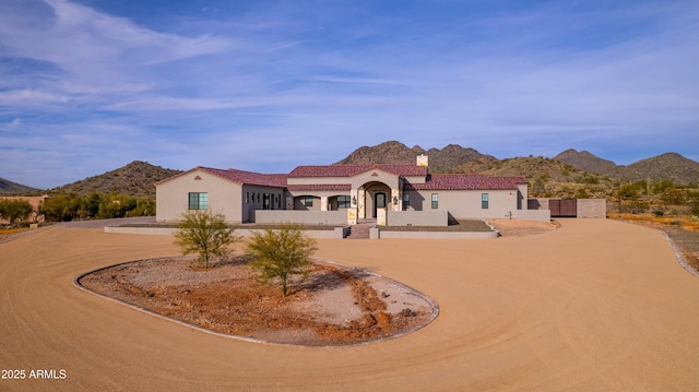 mediterranean / spanish home with a mountain view