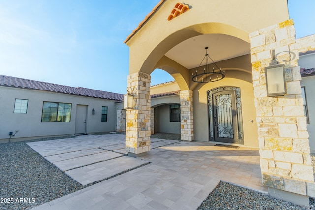 property entrance featuring a patio