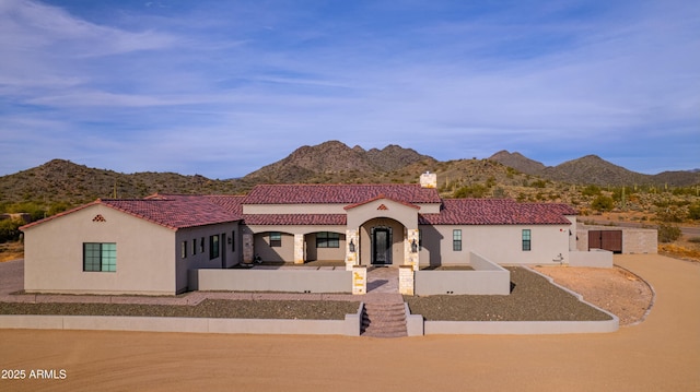 mediterranean / spanish house featuring a mountain view