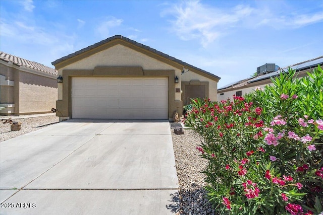 ranch-style home with a garage and an outbuilding