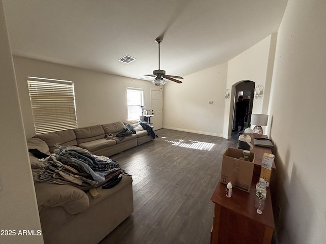 living room featuring ceiling fan and dark wood-type flooring