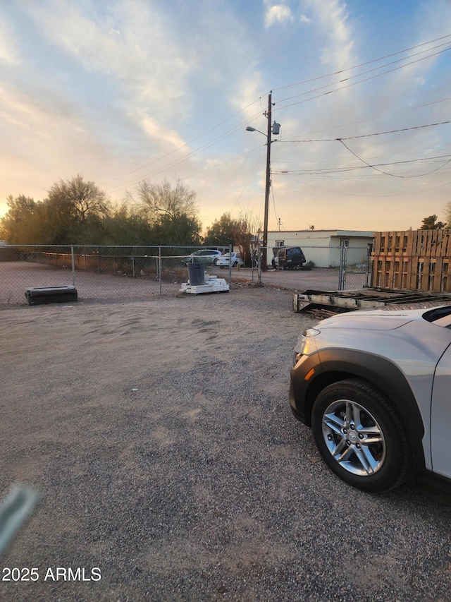 view of parking / parking lot with fence